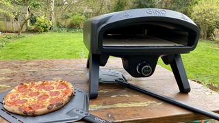 Gino D’Acampo Pizza Oven on table in garden