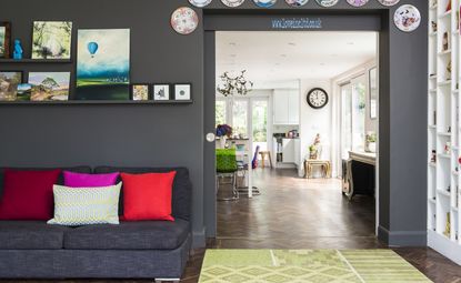 Grey living room with pink chair and painting