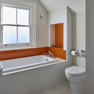 bathroom with bathtub and commode