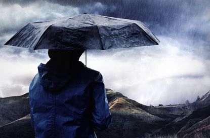 Shot of a woman covered with an umbrella watching a thunderstorm over a mountainhttp://195.154.178.81/DATA/i_collage/pi/shoots/783670.jpg
