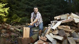 how to chop firewood: man chopping firewood