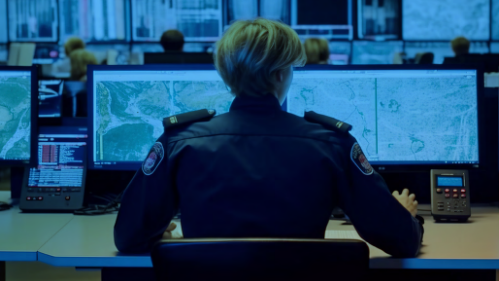 A woman in an ECC monitoring several displays. 