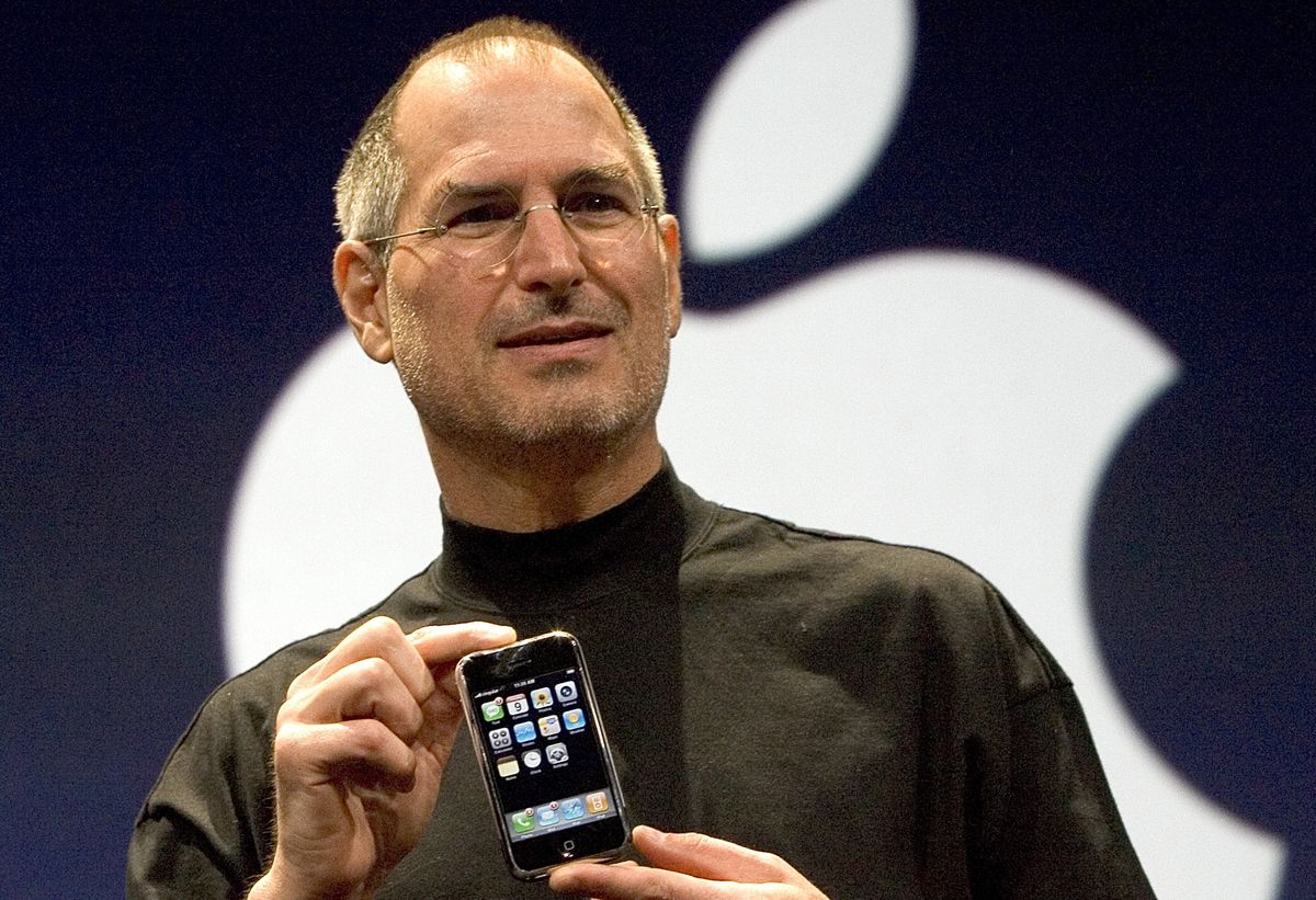 Steve Jobs holding original iPhone