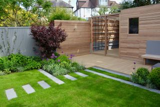 stepping stone ideas: path that blends into edging in modern plot designed by Tom Howard Garden Design