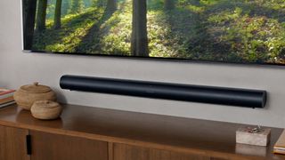 Hero image for best Dolby Atmos soundbars showing Sonos Arc mounted on a wall beneath TV screen