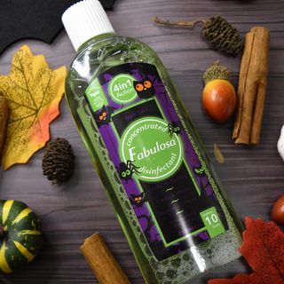 Fabulosa Apple spice scent on wooden counter surrounded by autumn leaves, pumpkin, cinnamon sticks and acorns