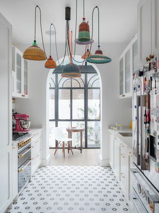 a kitchen with a large cluster pendant design