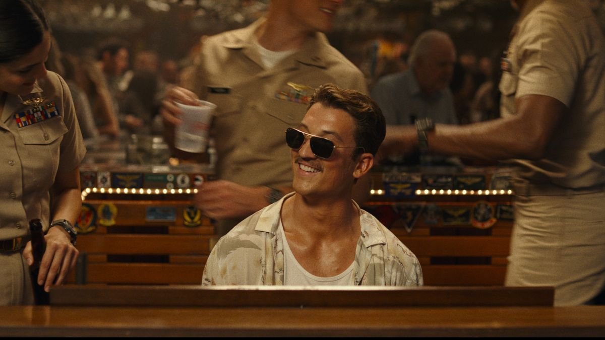 Miles Teller at a piano in Top Gun: Maverick