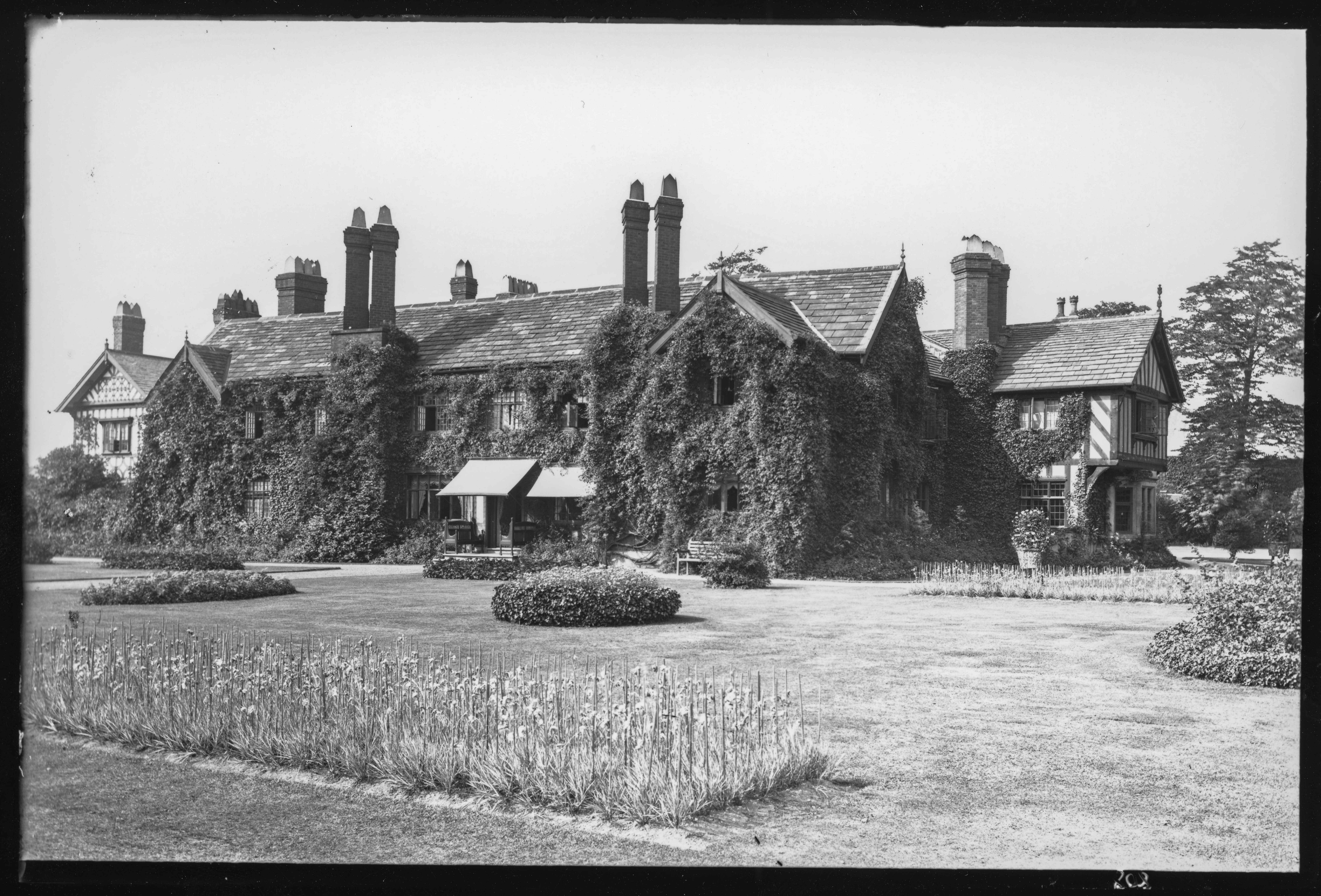 804, Worsley Old Hall, Manchester. The hall is now a public house. Here, it is covered in ivy.