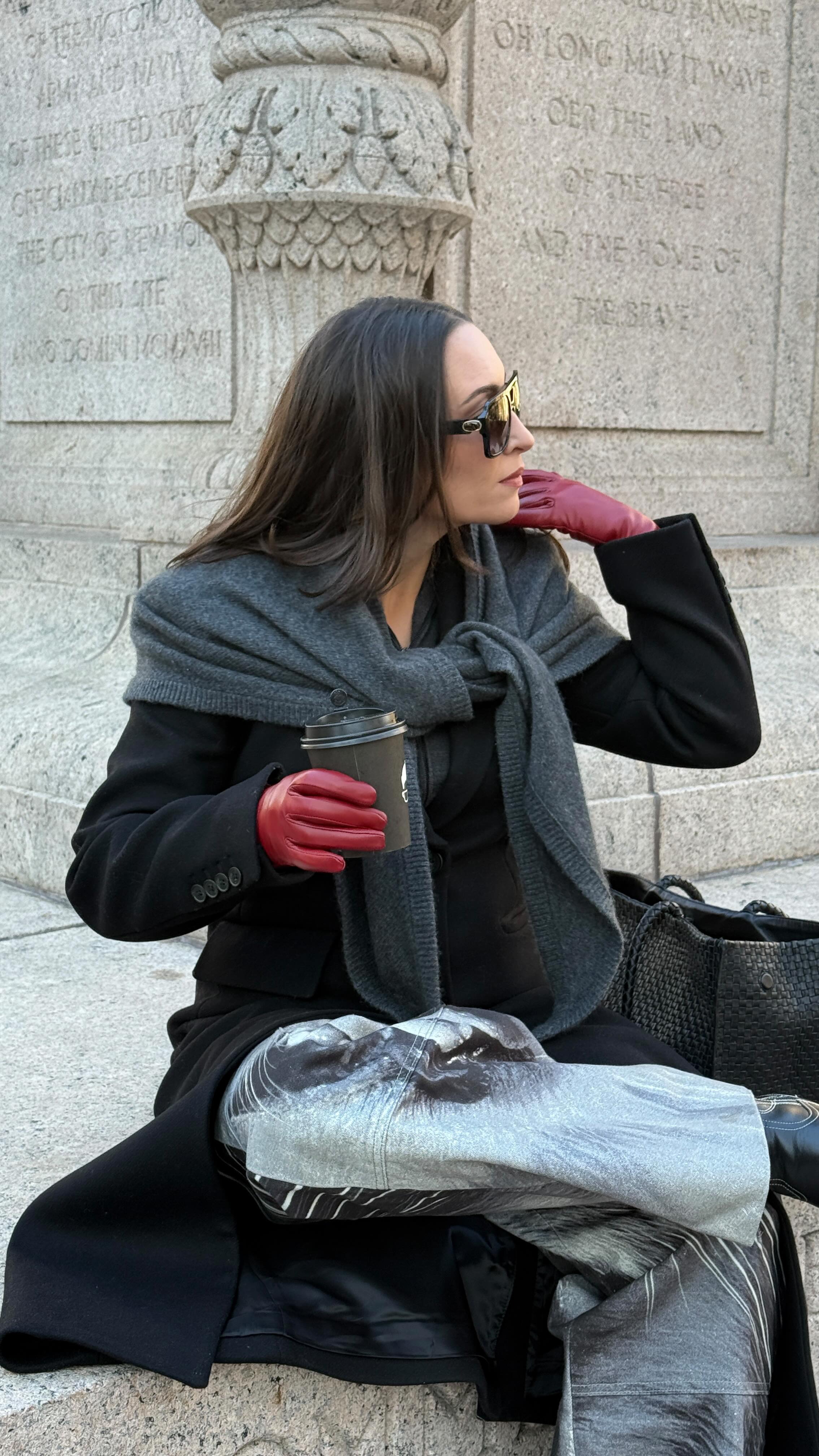 Influencer Bella Gerard wearing colored gloves with black outfit.