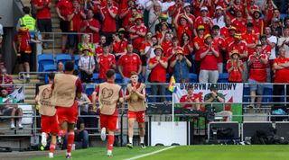 CARDIFF, WALES - JUNE 16: Welsh fans acknowledge David Brooks of Wales who makes his come back appearance following his recovery from stage 2 Hodgkin lymphoma during the UEFA EURO 2024 qualifying round group D match between Wales and Armenia at Cardiff City Stadium on June 16, 2023 in Cardiff, Wales. (Photo by Robin Jones/Getty Images)