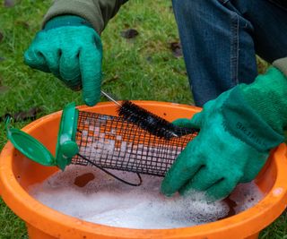 Cleaning a bird feeder