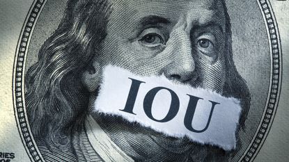 The acronym IOU is taped over the front of a hundred-dollar bill.