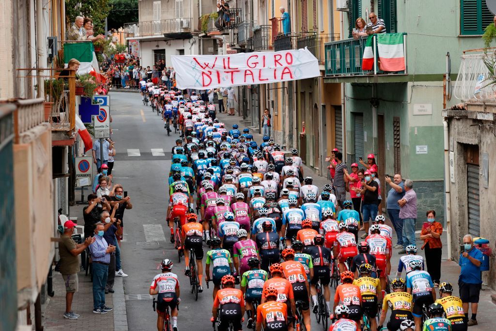 Spectators cheer as the pack rides through a village during the 4th stage of the Giro dItalia 2020 cycling race a 140kilometer route between Catania and Villafranca Tirrena Sicily on October 6 2020 Photo by Luca Bettini AFP Photo by LUCA BETTINIAFP via Getty Images