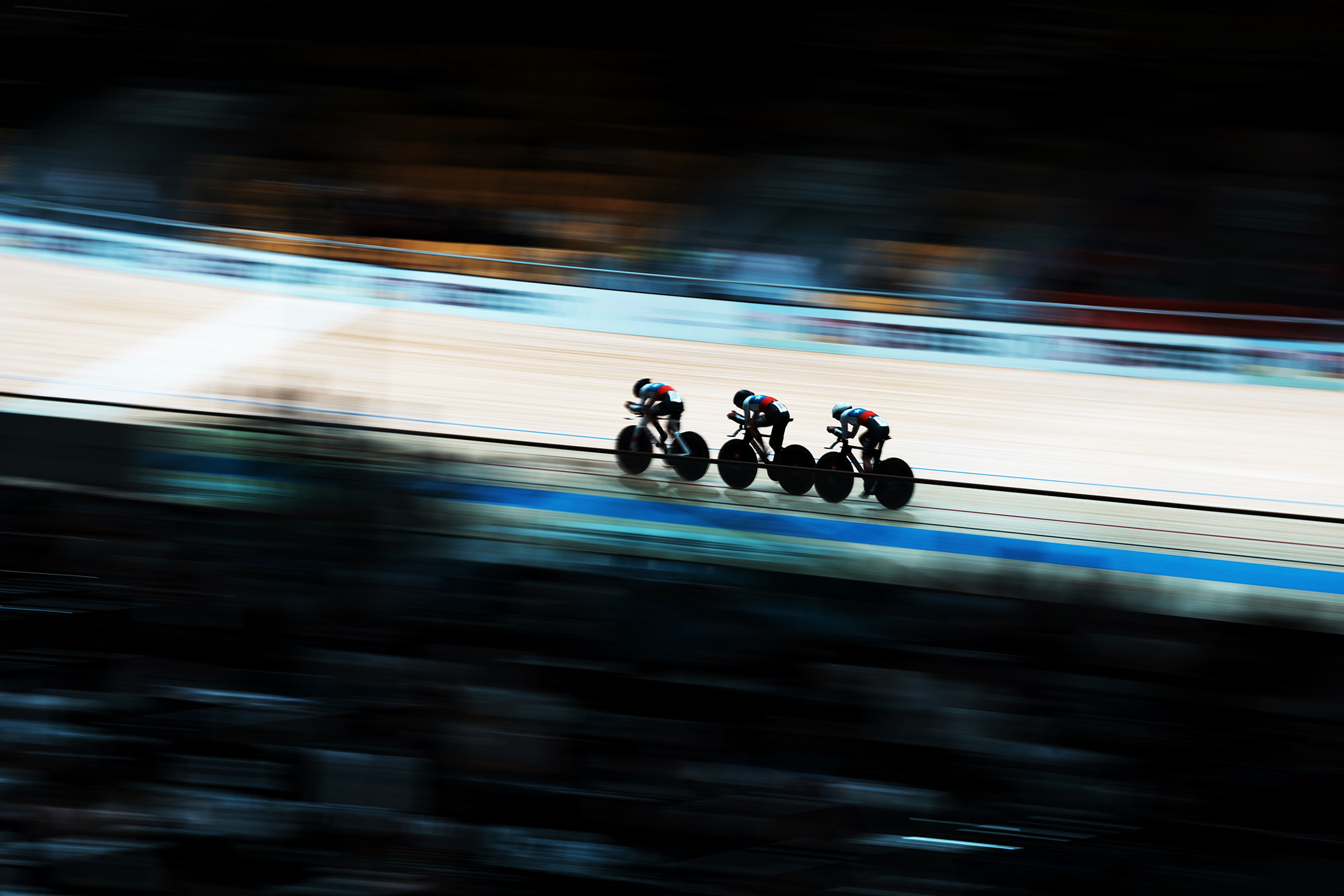 A long shot of a three-rider team competing during the women's team pursuit qualifying on day one of the 2026 Track World Championships