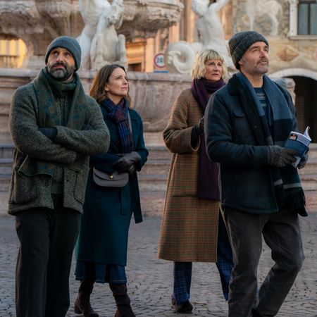 a group of friends walk through an italian square in a still from the four seasons season 2