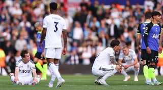 Leeds United players look dejected after a 4-1 loss at home to Tottenham sees them lose their Premier League status in May 2023.