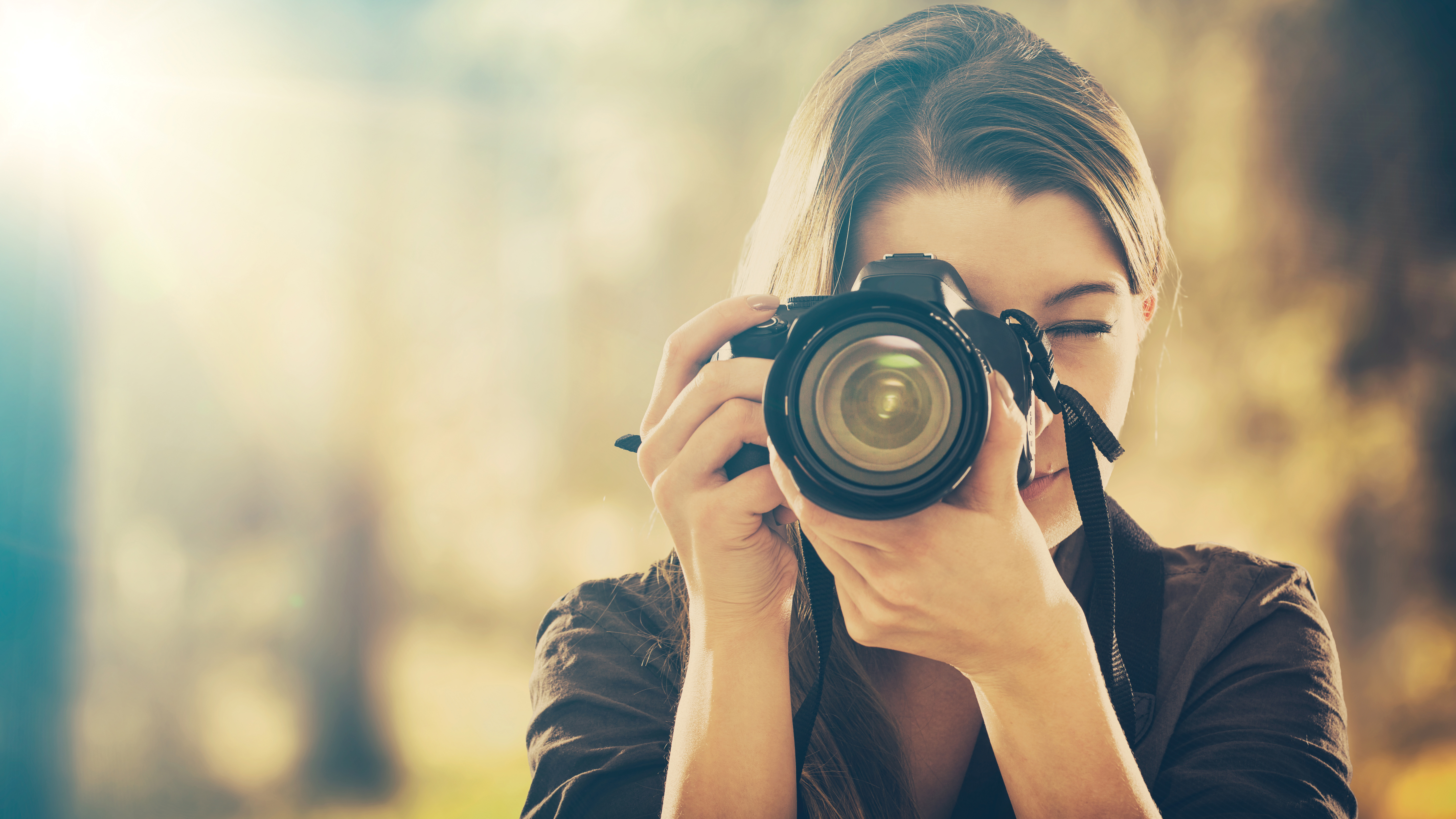woman holding a professional DSLR camera