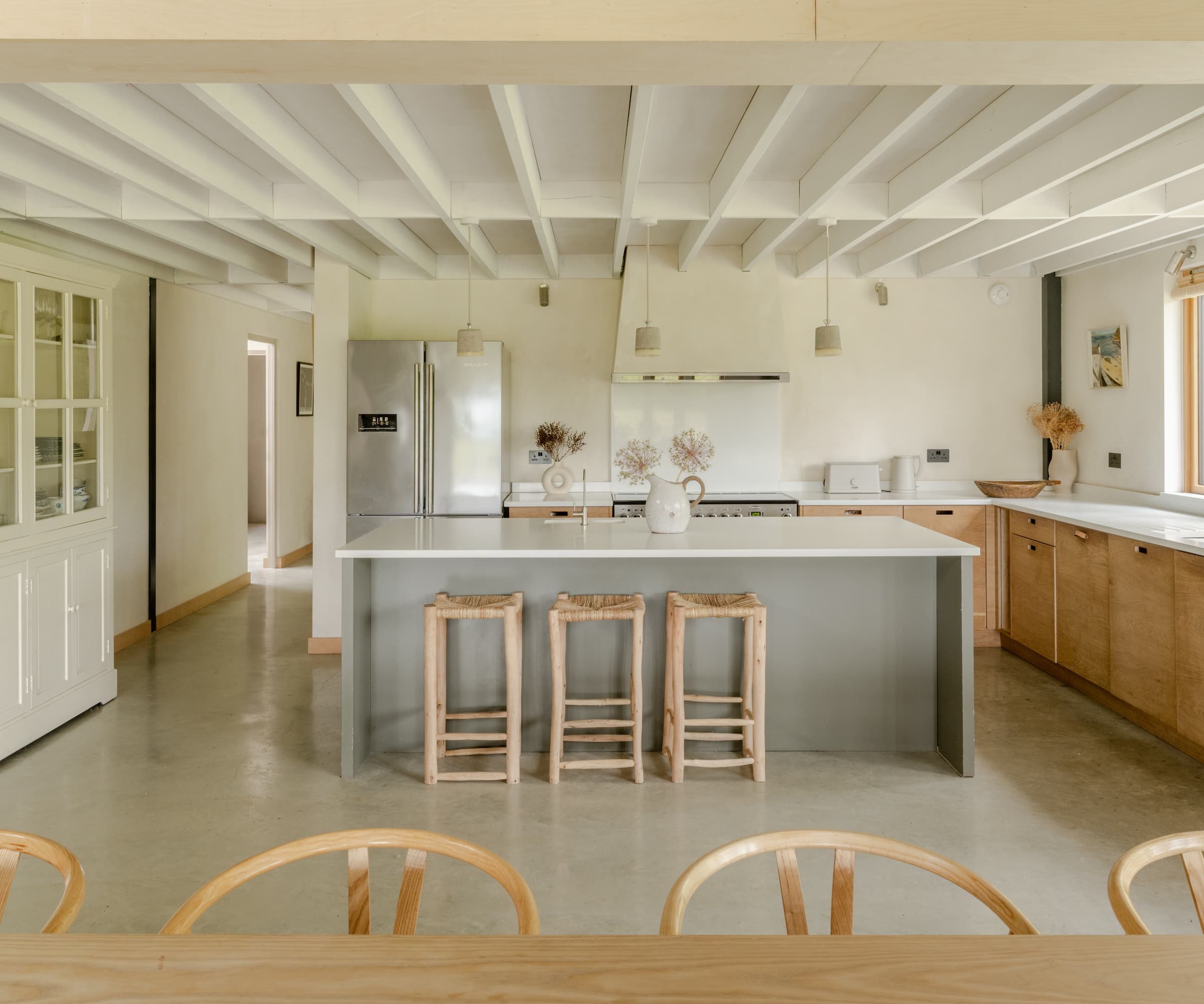 A kitchen-diner with a central island and wooden cabinets