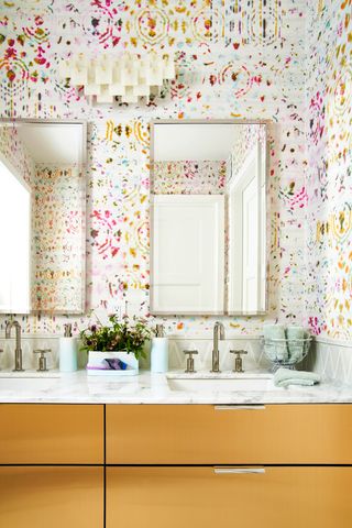 Colorful family bathroom with double sink and large mirrors