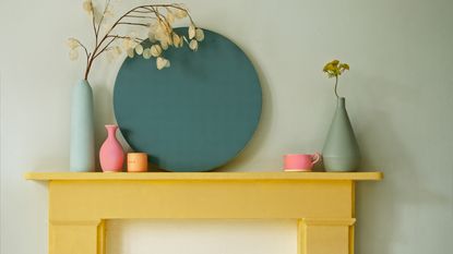 Blue shaker kitchen with black walls and pink island