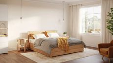 A modern, warm bedroom with a bed frame and mattress from Emma Mattress.