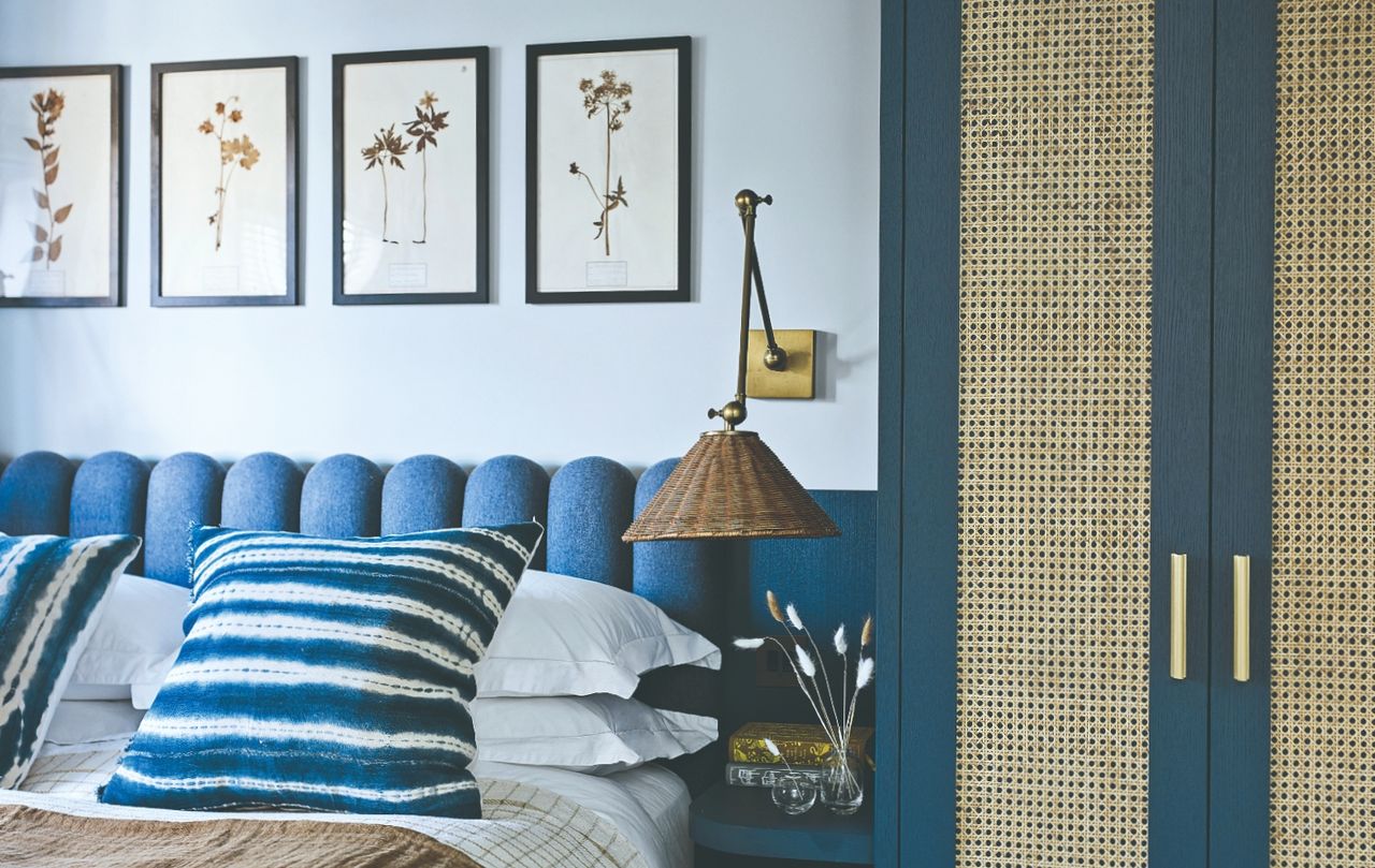 Blue bedhead and vertical artwork with a rattan closet