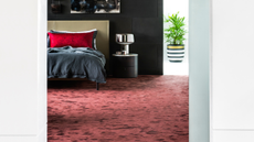 a plush dark red carpet in a modern bedroom shot between two open doors