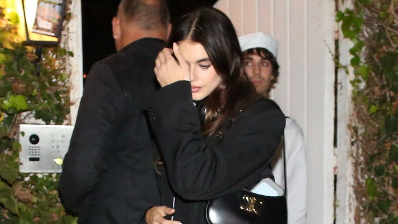 Kaia Gerber wears a black blazer, riding boots, and carries a Celine bag at Billie Eilish&#039;s Halloween party