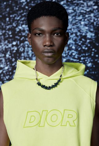 Man in yellow Dior Parley by the Oceansvest hooded top