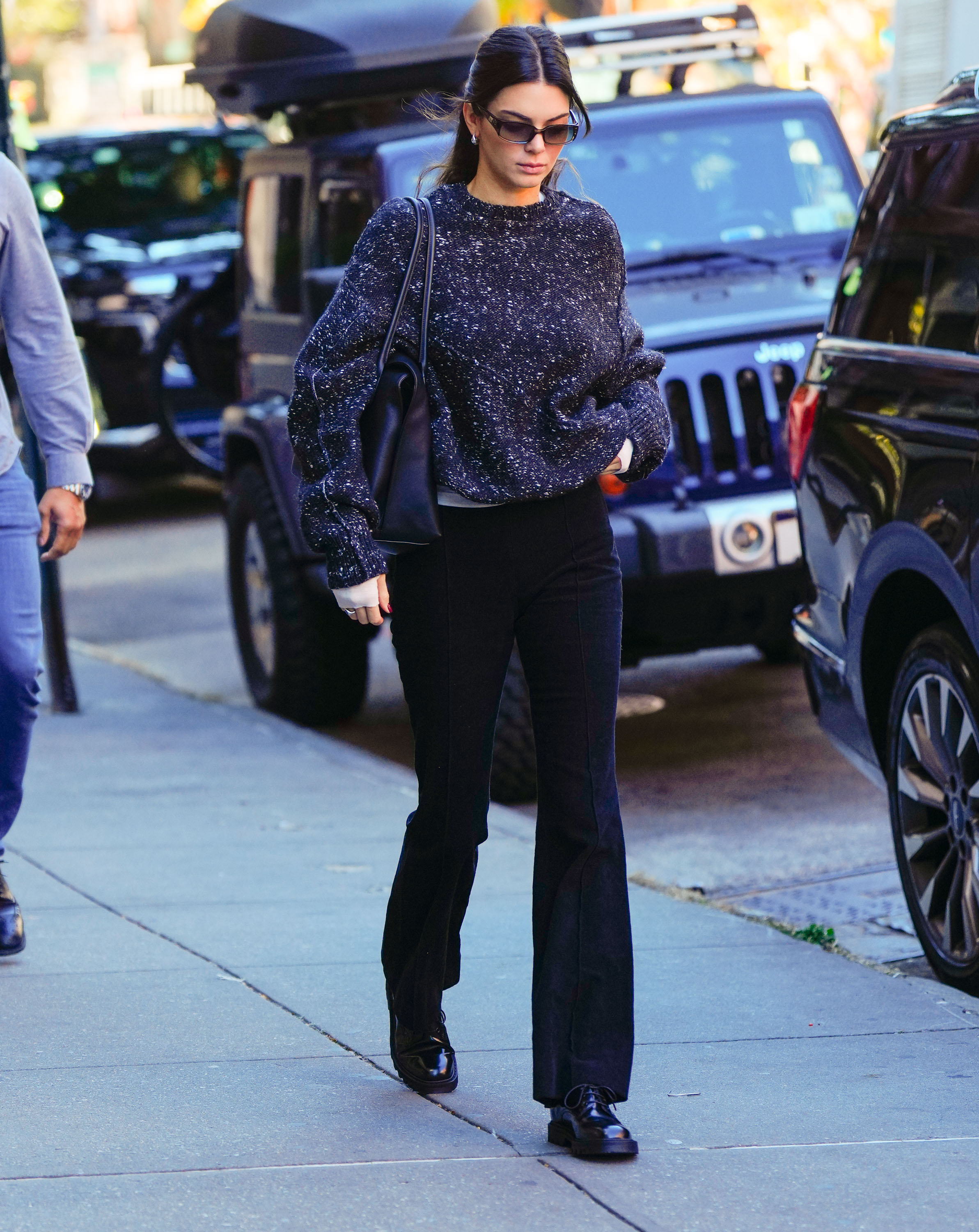 An image of Kendall Jenner wearing bootcut leggings with lace-up flats