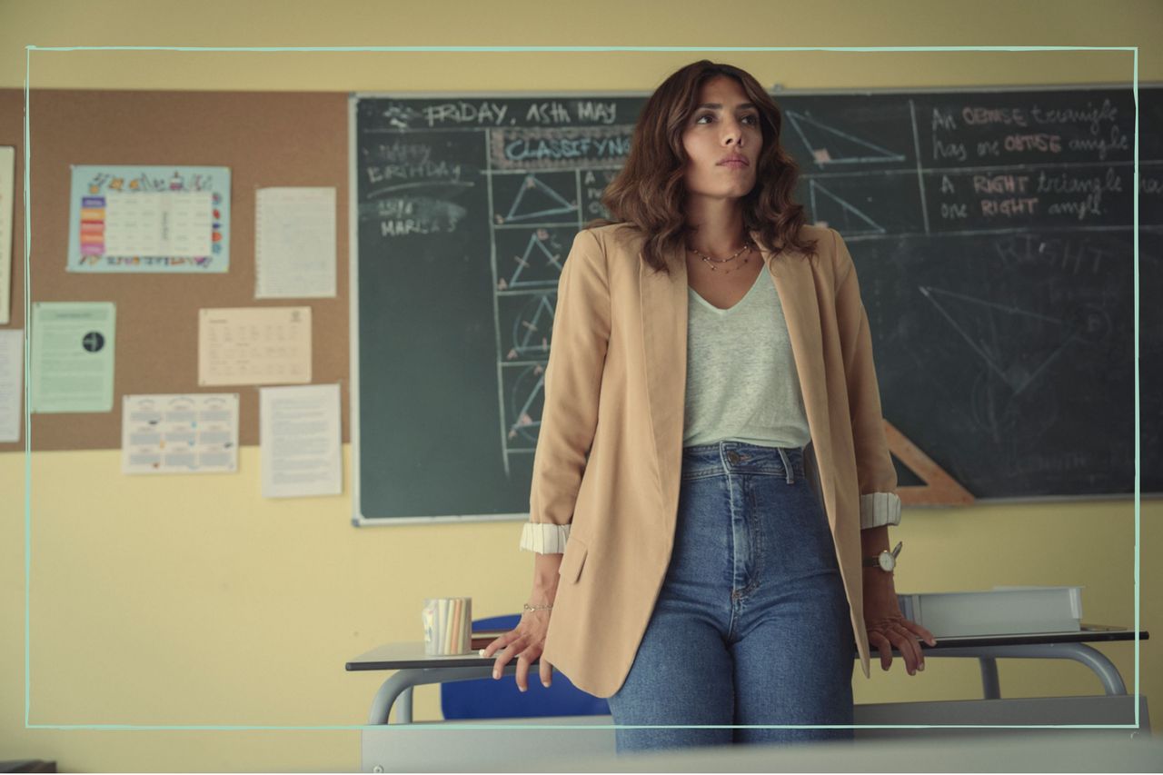 Erin Carter leaning against a desk in a classroom