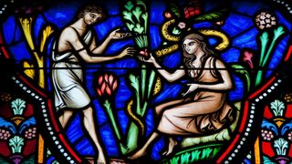 a stained glass window of Adam and Eve eating fruit from a tree