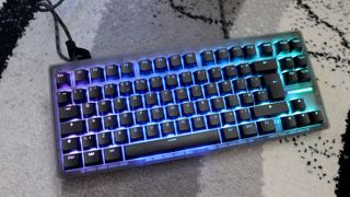 The Wooting 8-HE on a mouse pad with RGB lighting enabled.