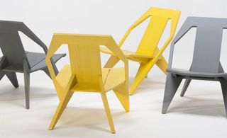 Two yellow and Two Grey chairs photographed against white background