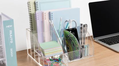 Desk with clear desk organizer and notebooks