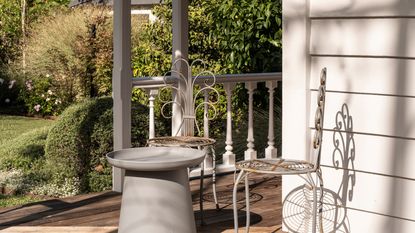 A small garden with patio chairs and a table