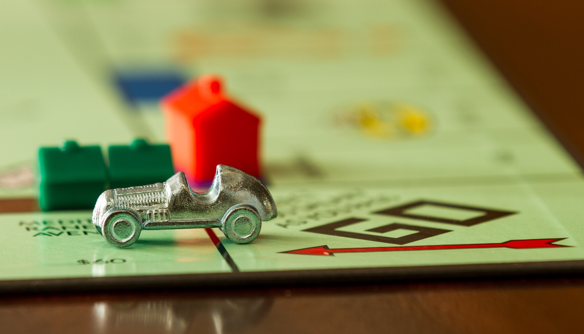 Car from the game Monopoly speeding past