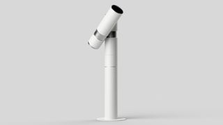 A sleek, modern white telescope mounted on a cylindrical base, angled slightly upward against a neutral background