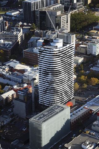 Swanston Square Apartment Tower in Melbourne by ARM Architecture is a mixed use development incorporating a striking balcony profile that defines the exterior