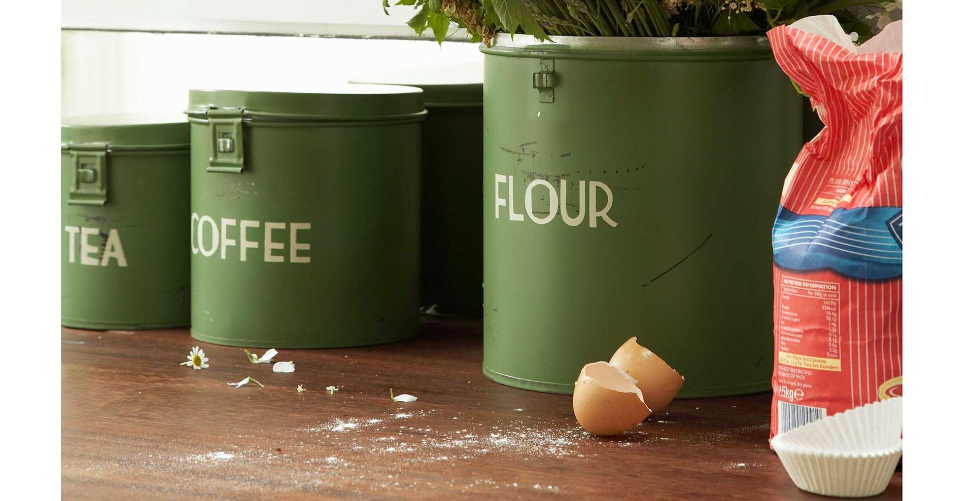 kitchen with green enamel storage tins with flour showing one of the main things you should never pour down drains