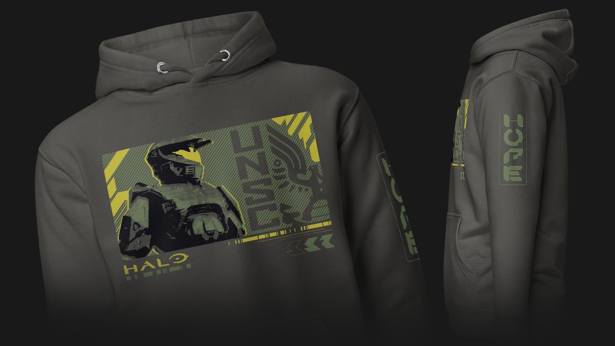 Grey hoodie featuring a stylized graphic of a futuristic soldier helmet and text. Vibrant green and yellow details create a bold, modern look.