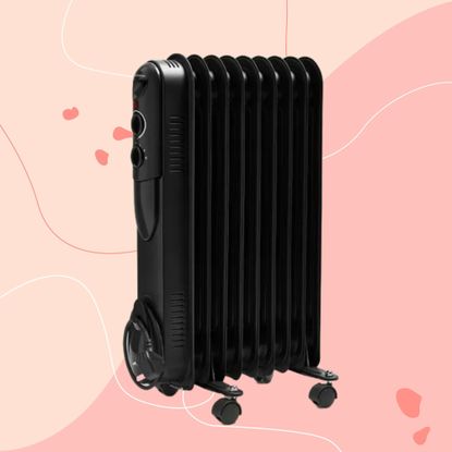 Black Dunelm oil-filled radiator on a pink background