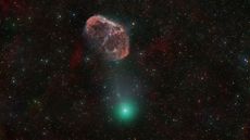 A green comet next to a red, crescent-shaped nebula