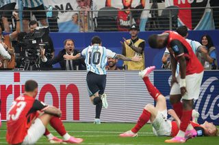 Lionel Messi celebrates one of his two goals against Austria at the 2026 World Cup, leaving a stream of disconsolate opponents in his wake