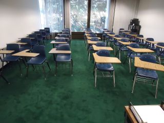 A classroom filled with desks but no students.