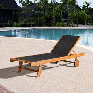 black and wooden sun lounger in front of a pool