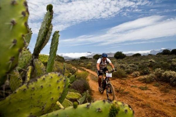 A rider passes through desert terrain at the Cape Pioneer Trek