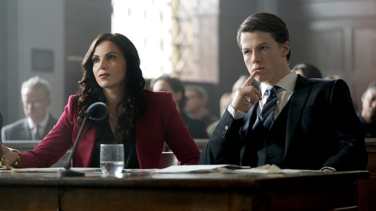 Jocelyn and Rudy sitting at table in the courtroom on USA's The Rainmaker Season 1