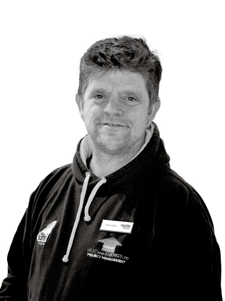 A portrait of David Hilton, a professional featured in an article about heat pumps, wearing a black hoodie with a logo.
